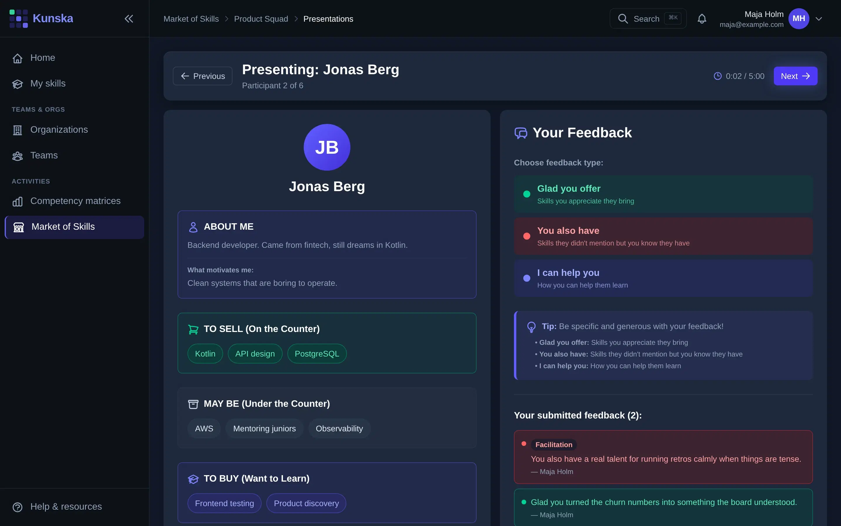 A presentation: the booth on stage, and the three kinds of feedback beside it.